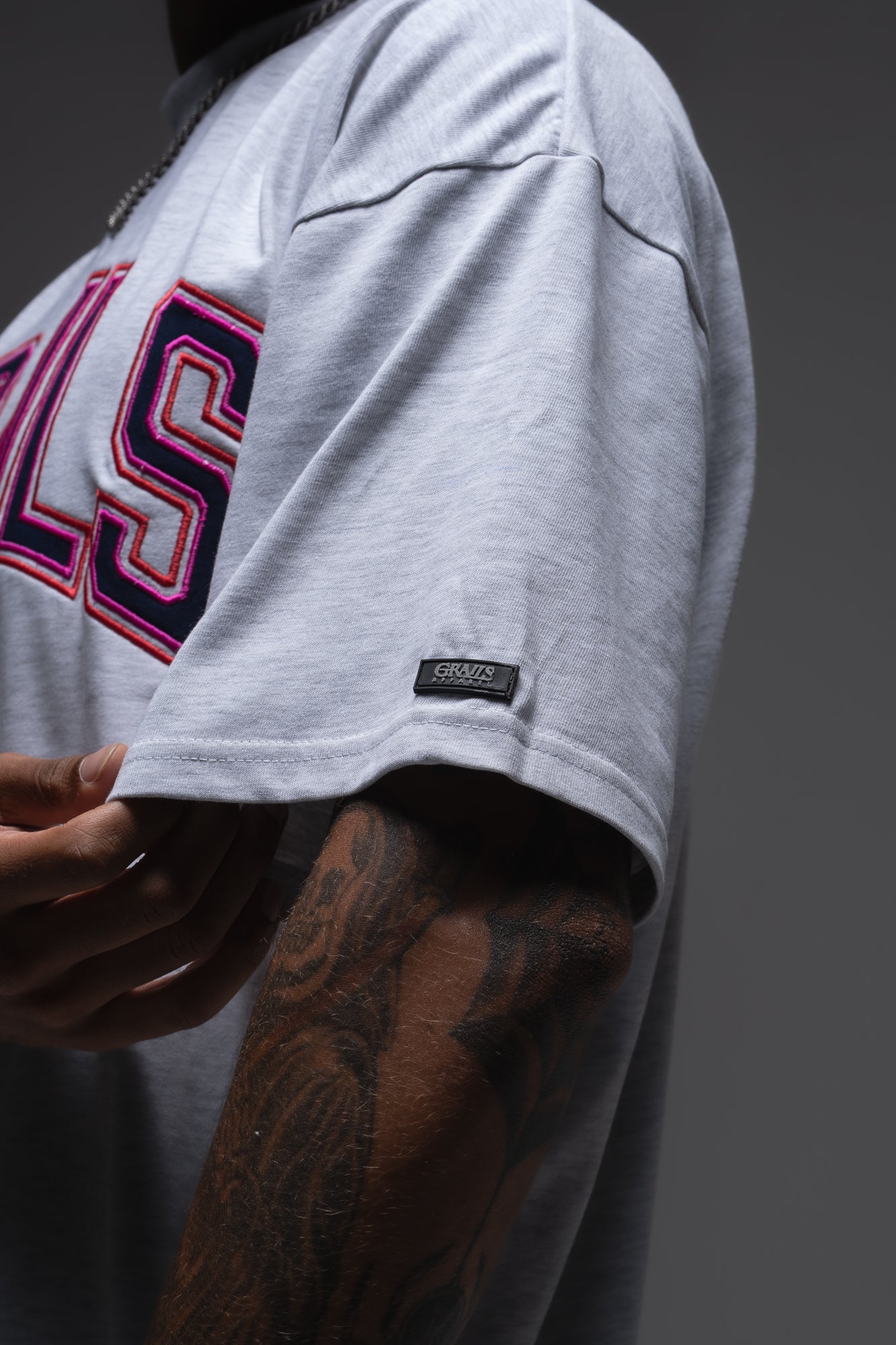 Varsity Tee 3D puff monogram at back of neck and rubber Grails sleeve tab detail - snow marle heavyweight tee