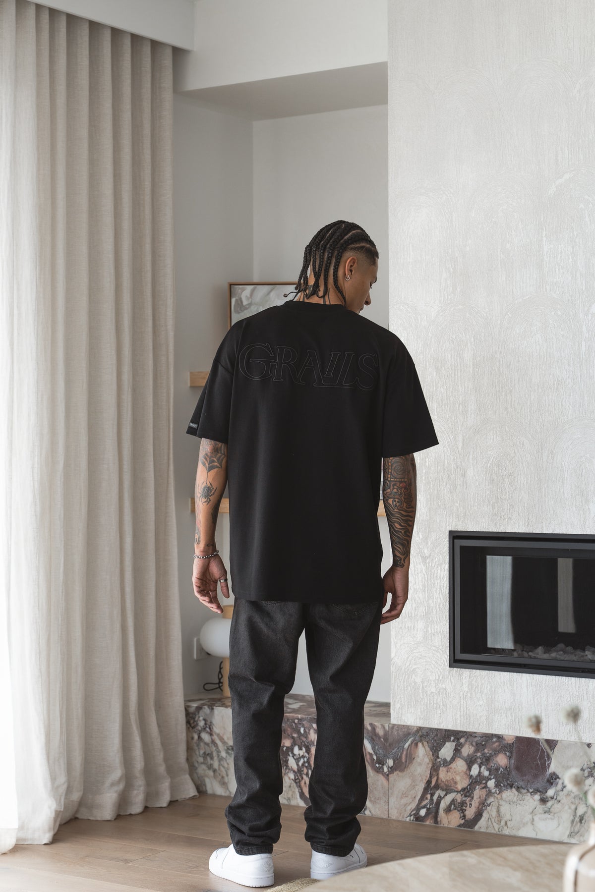 Classic Tee in black worn back-on, tonal black-on-black GRAILS back embroidery - Grails Apparel 260gsm heavyweight cotton tee