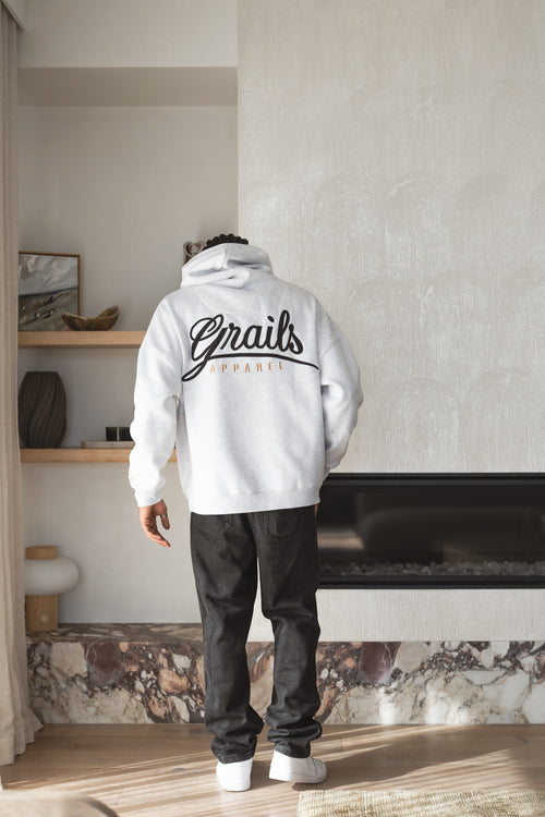 Calligraphy Hoody back view - large format Grails applique with satin stitch outline above champagne 3D puff Apparel script, 460gsm oversized hoodie in snow marle
